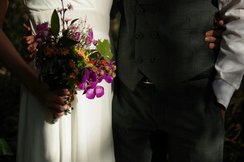 a man and woman holding flowers in their hands