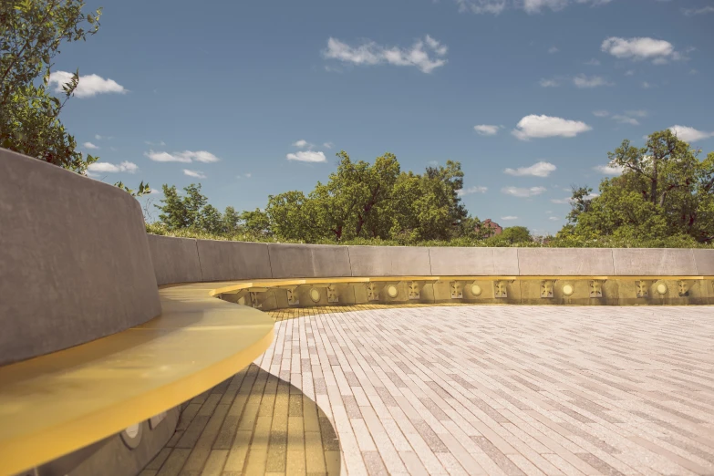 a yellow bench that is sitting in the cement