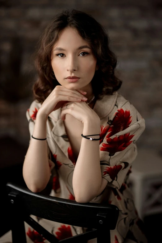 a woman with long hair sitting at a table