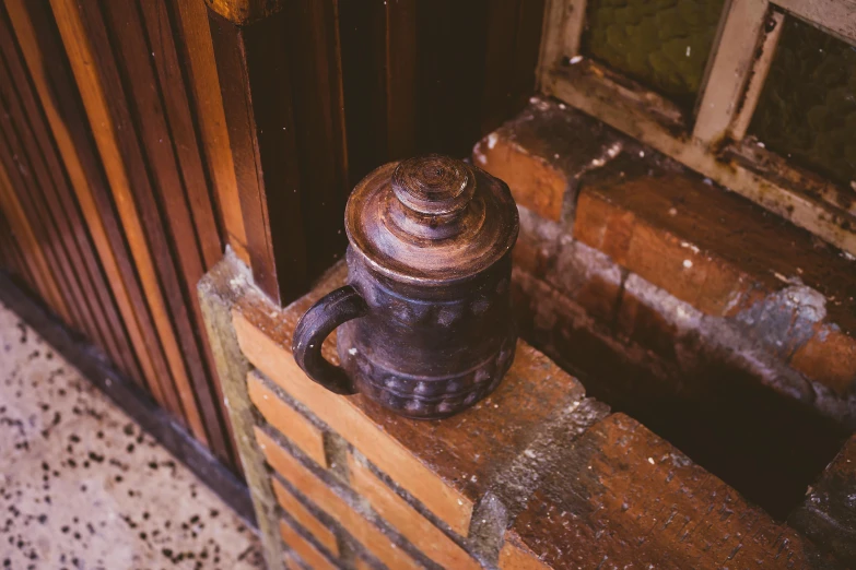 a large, rustic looking, old bottle with rusty paint