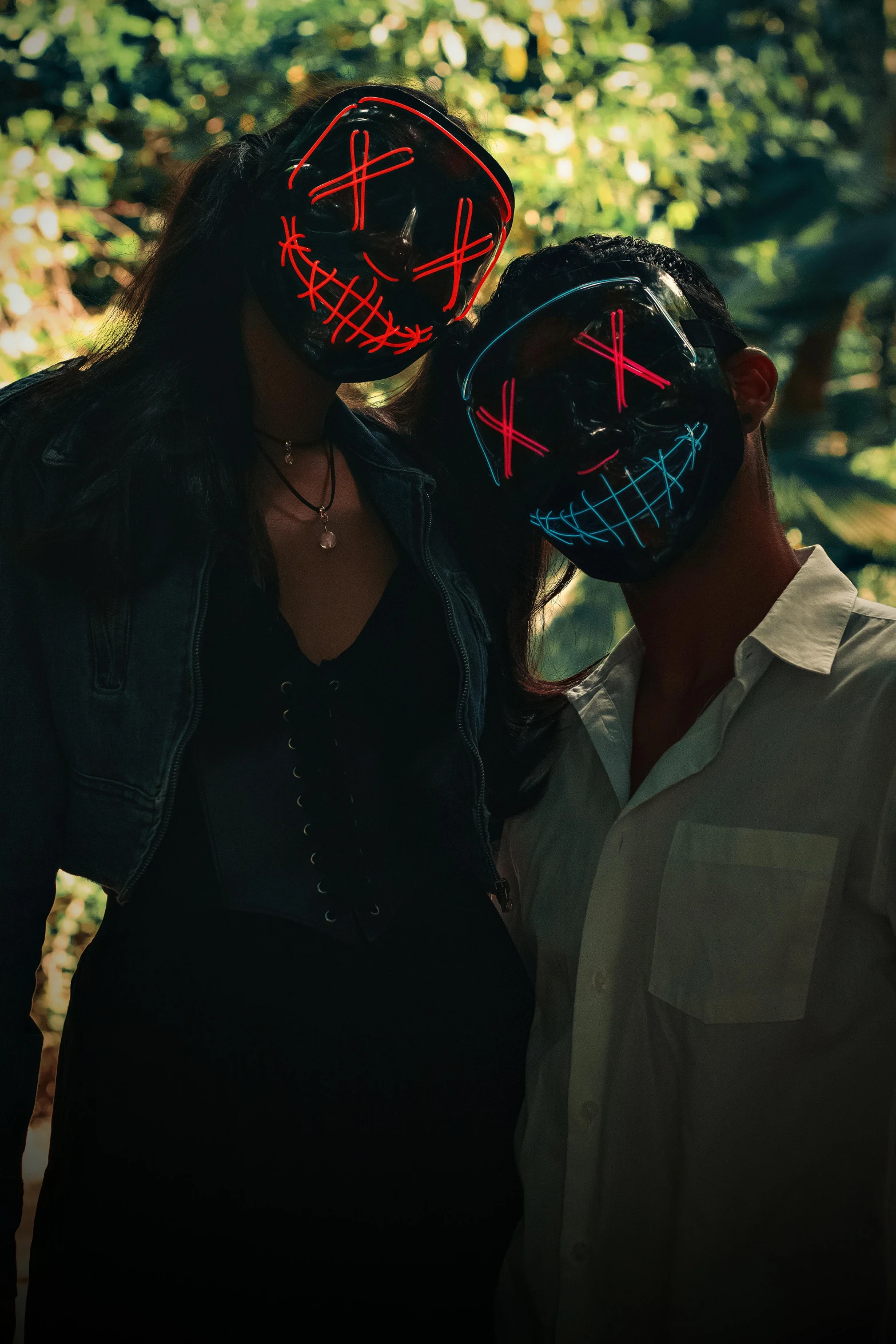 two people with neon masks on their faces