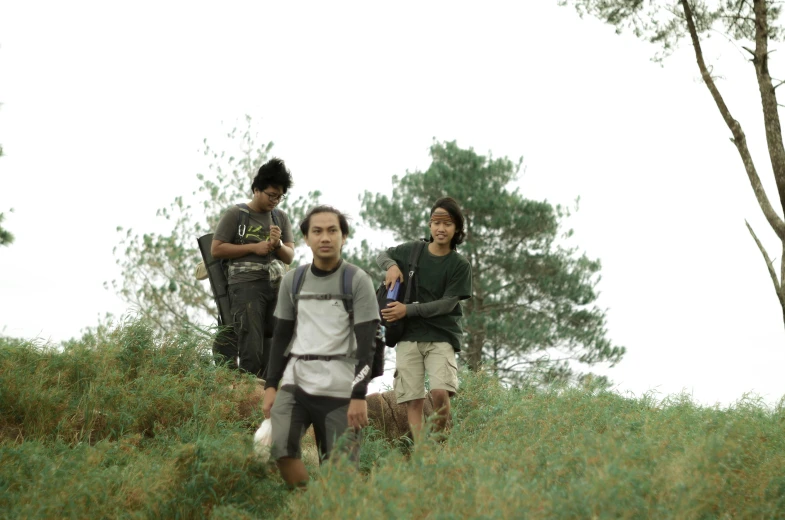 a group of people standing on a lush green hillside