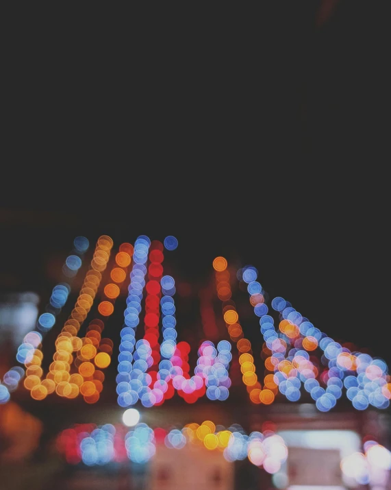 blurry pograph of a building in the night with blurred lights
