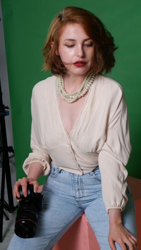 a woman sits with her head down and holds the camera up