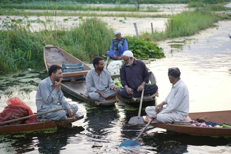 men on boats are sitting in the water