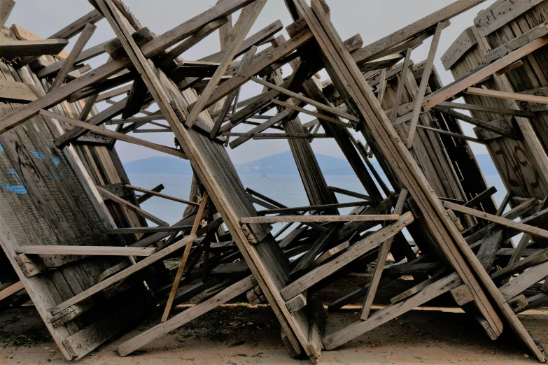 the structure was made out of old broken wood and is sitting on the beach