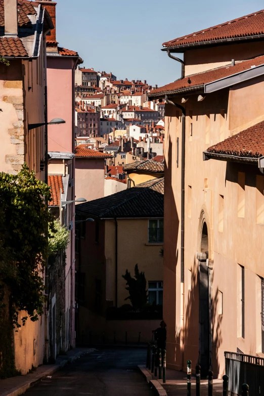 narrow, empty street with houses in the background