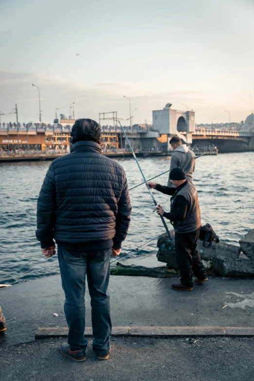 a father and son are fishing in the harbor