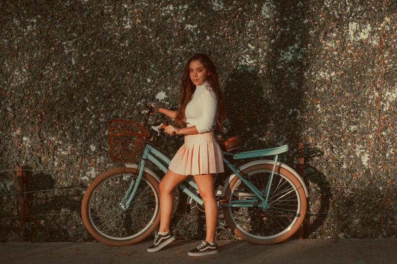  in short skirt standing next to bicycle