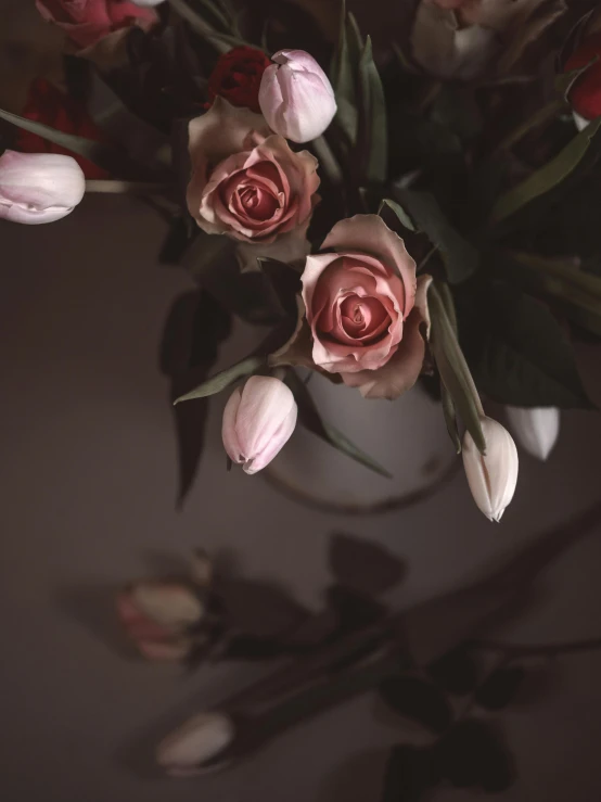 the white and pink flowers are arranged together in a vase
