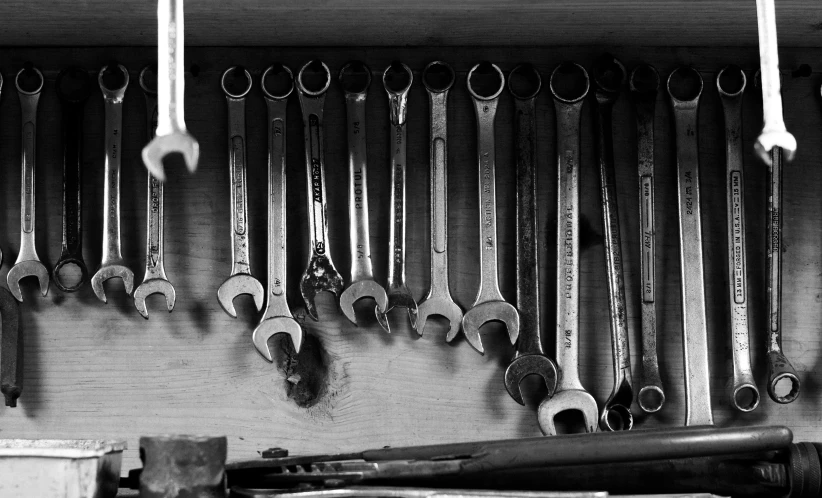 there are lots of wrenches hanging on the wall