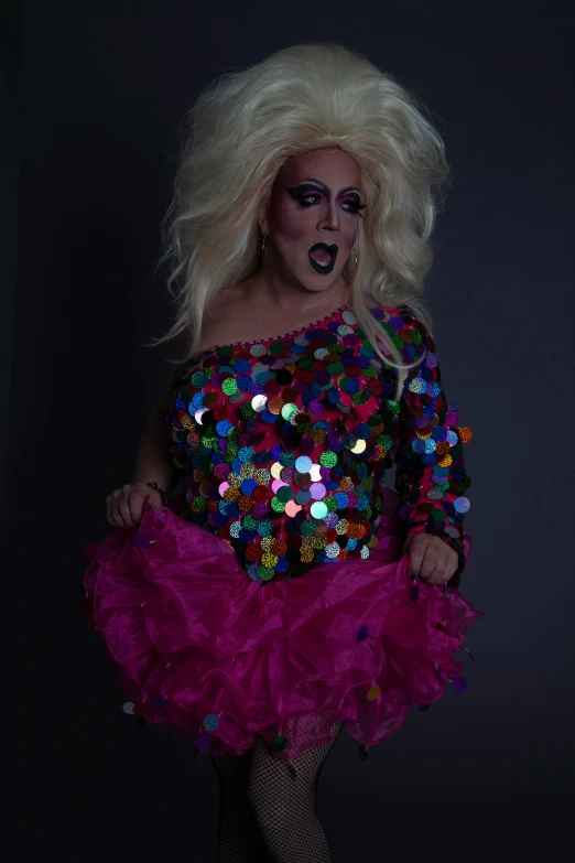 a woman is dressed as a drag queen