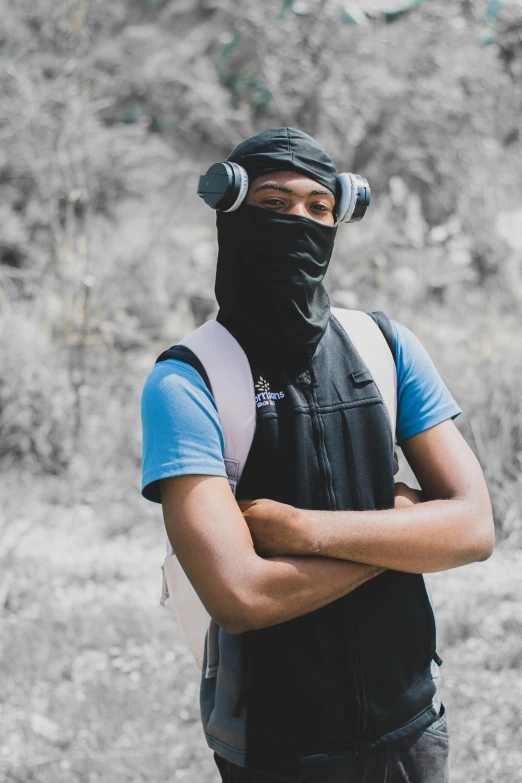 a man wearing a black mask and a blue shirt