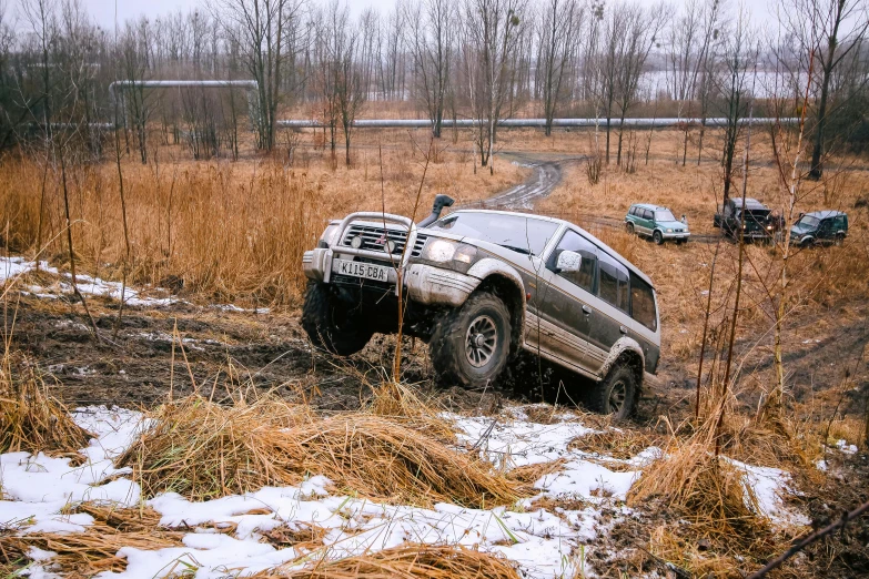 a truck sits in the middle of a snowy field