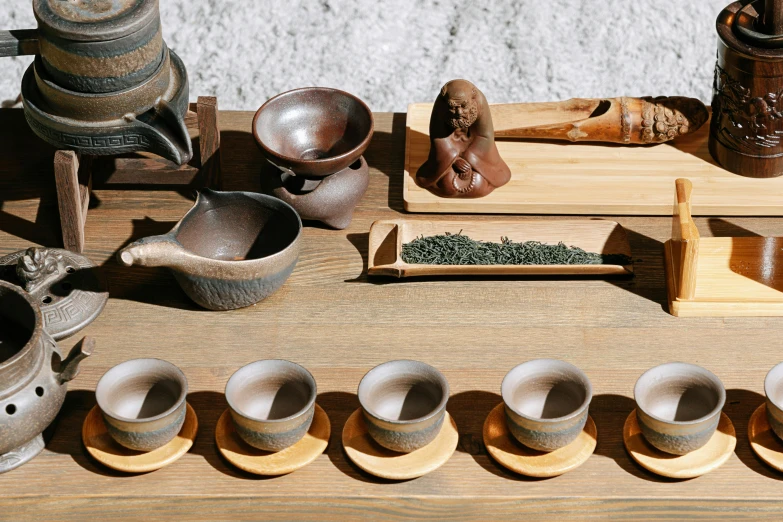 a wooden table topped with old fashioned pottery