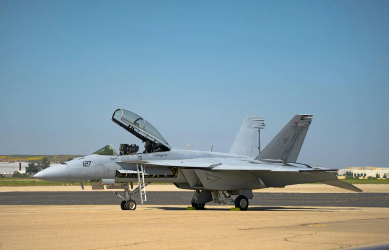 a fighter jet parked on the runway in an airport