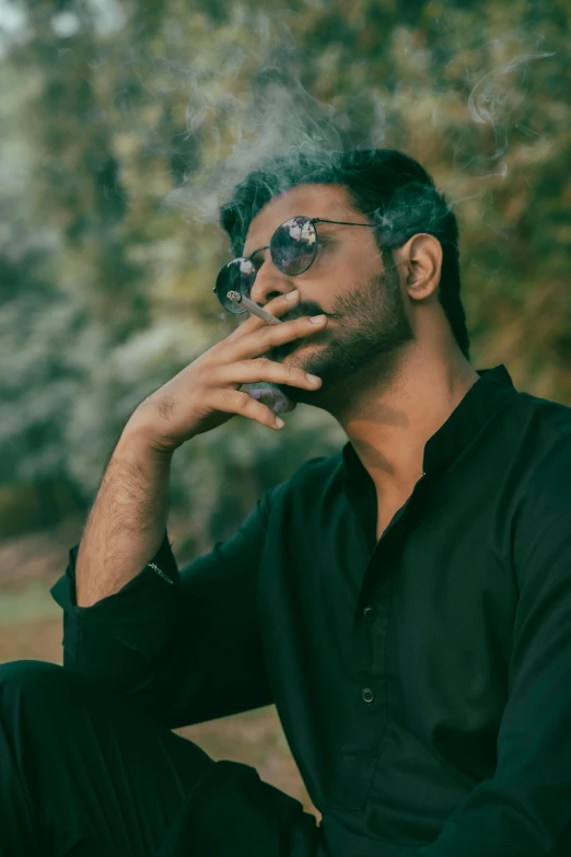 an indian man smoking a cigarette, with smoke from his mouth