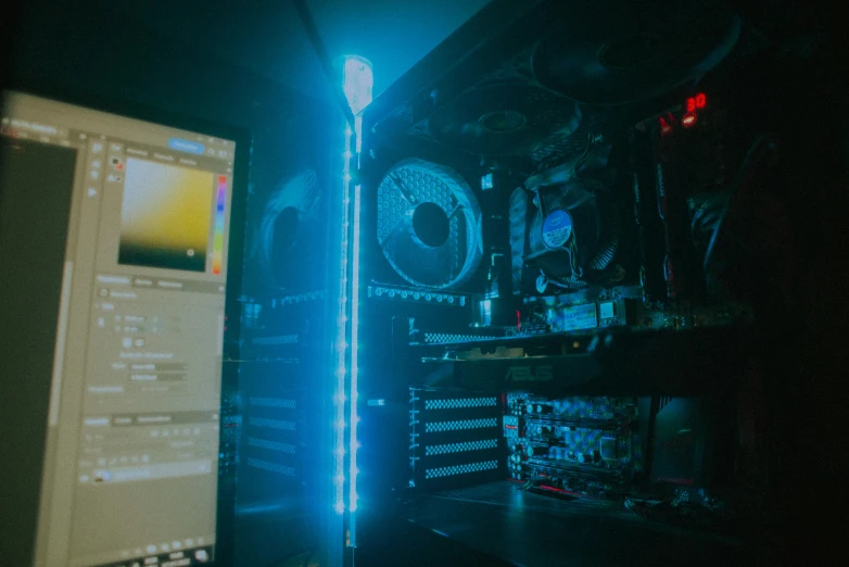 a computer and its monitor in a dark room