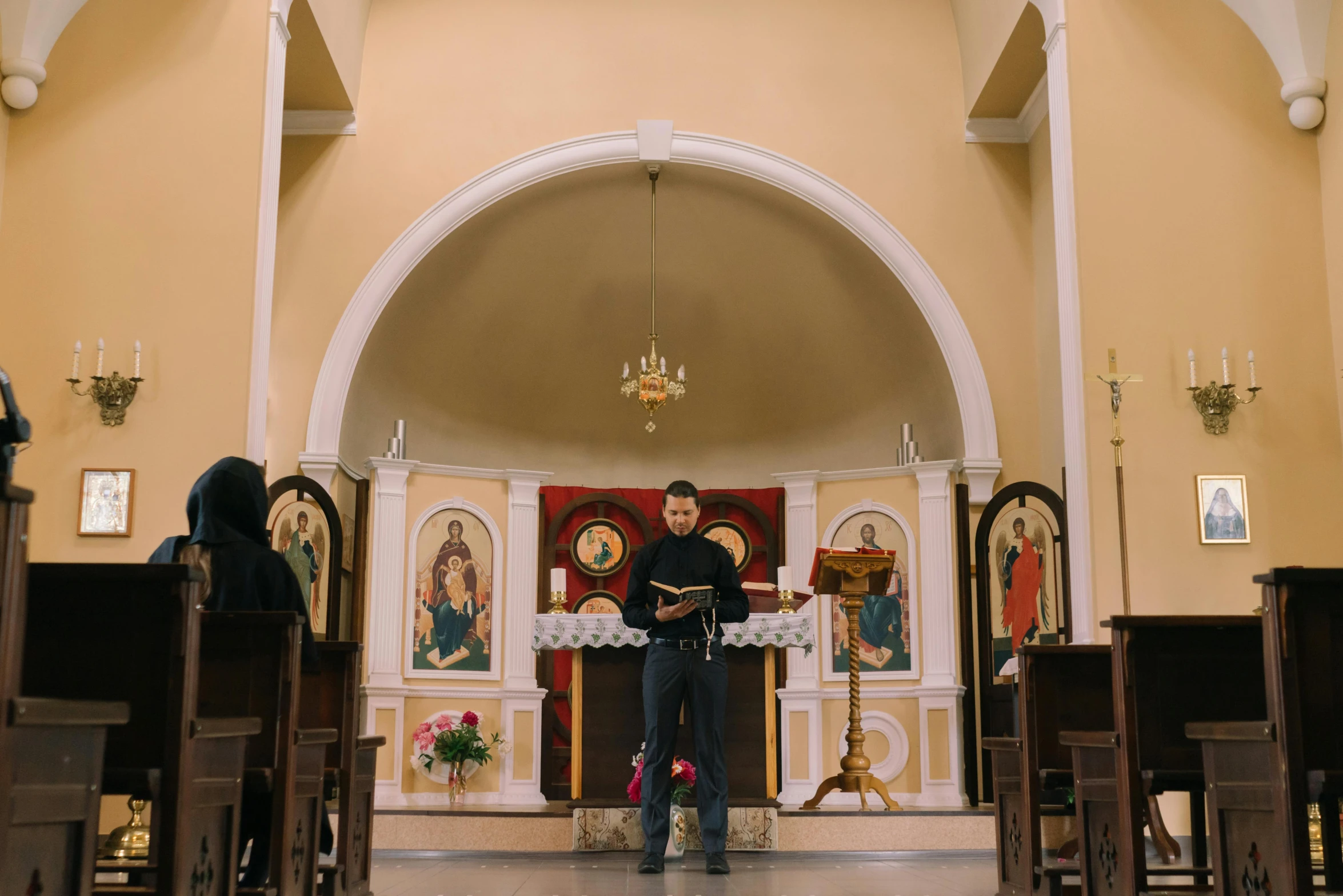 an altar where the priest holds the cross in his hands