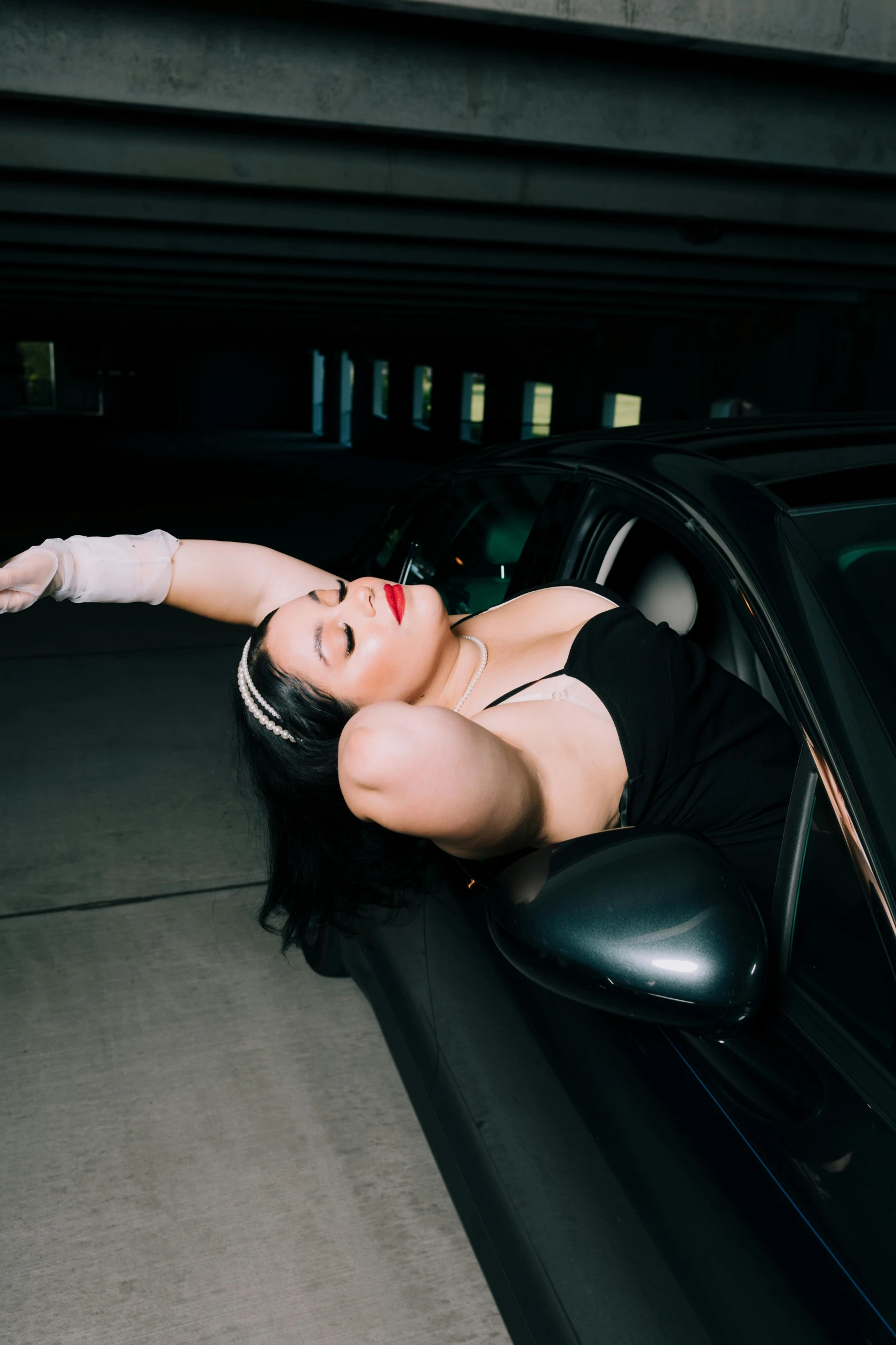 a woman that is leaning on the handle bars of a car