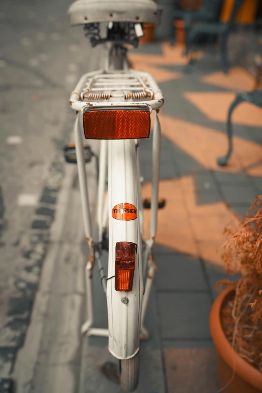 the light of a white bike is reflecting on the pavement