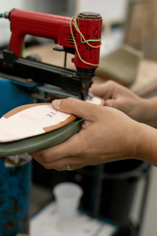 someone is working with their small machine for crafts