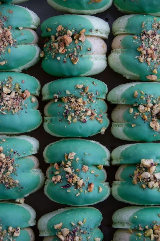 a number of doughnuts are topped with colorful frosting