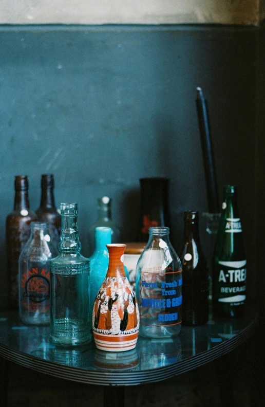 several glass bottles sitting on a table together