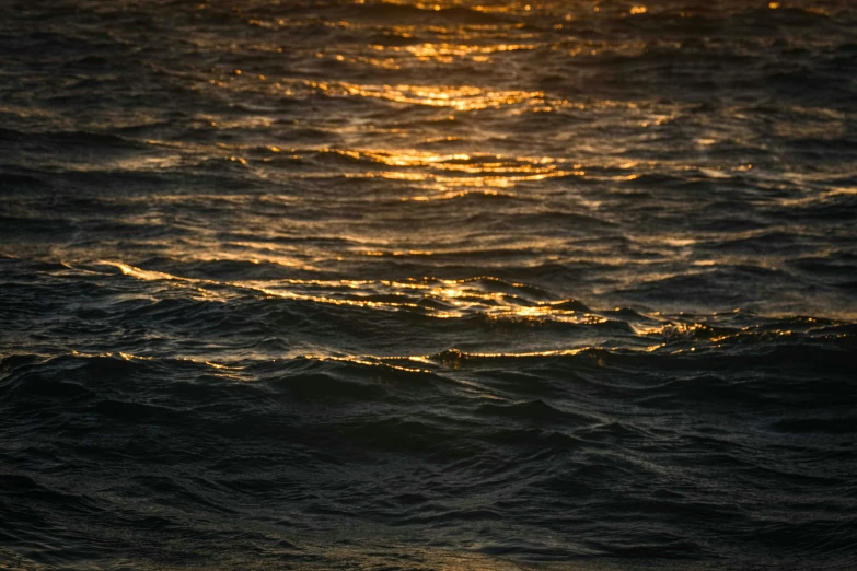 a pograph of the sunset over rough water