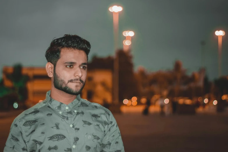 a man standing in front of a building at night