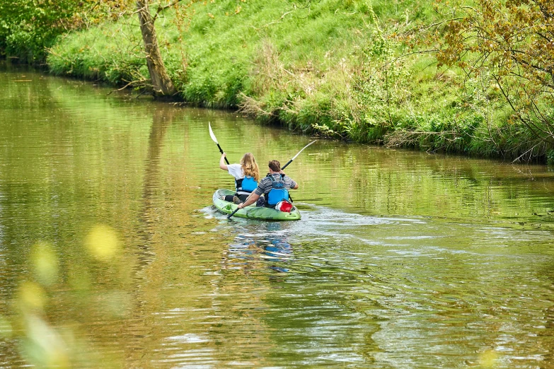 two people on a canoe paddling through water