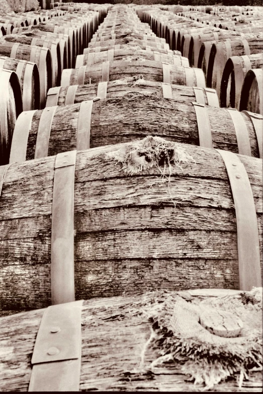 wooden barrels are stacked with each other