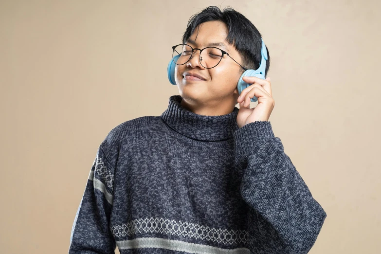 a man with glasses talking on the phone