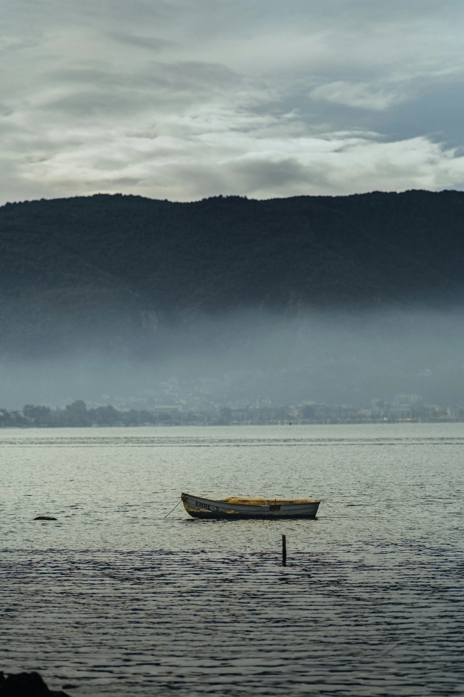 two canoes on a body of water in front of a mountain