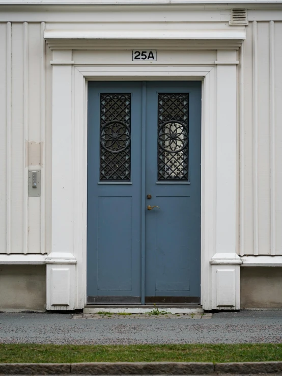 a pair of blue doors and windows on a building