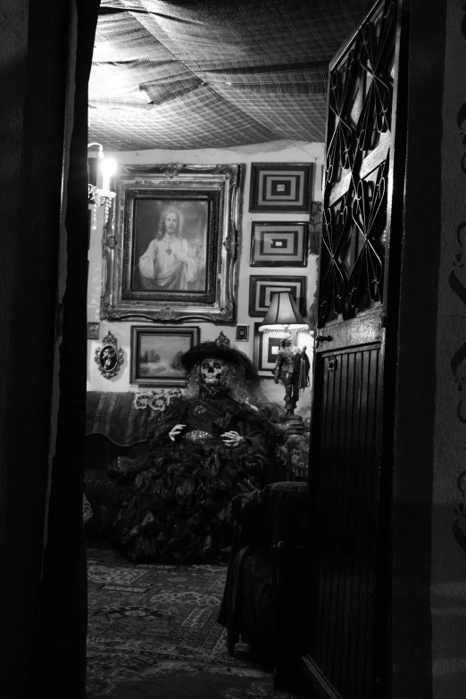 a hallway in a house with paintings and pictures on the wall