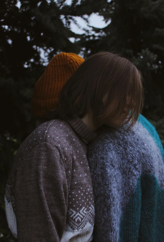 two children with colorful sweaters, one child with a beanie