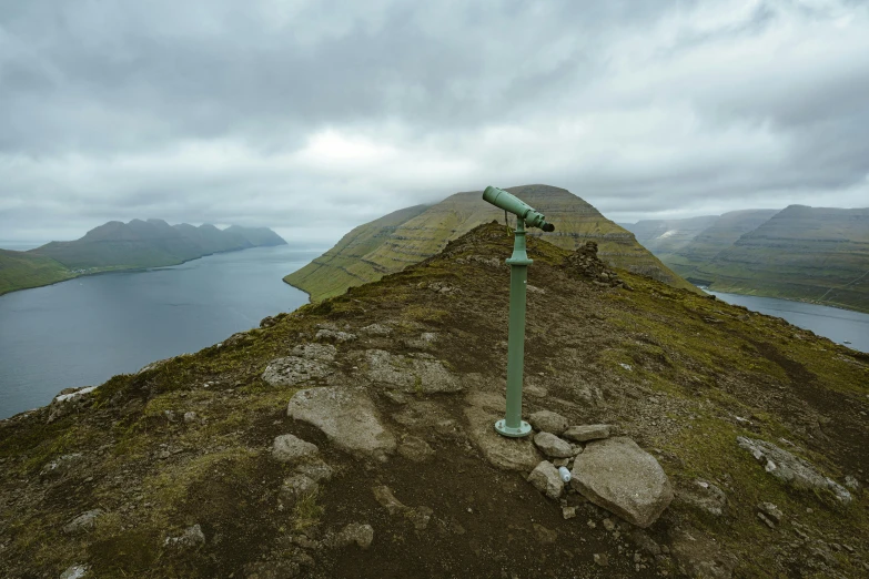 a view of the sea, sky, mountains, and land from a high point of view