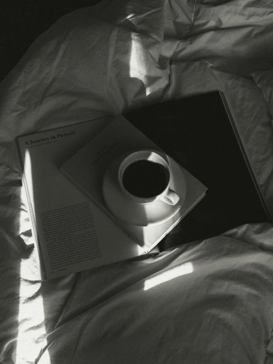a black book a cup and a cup of coffee