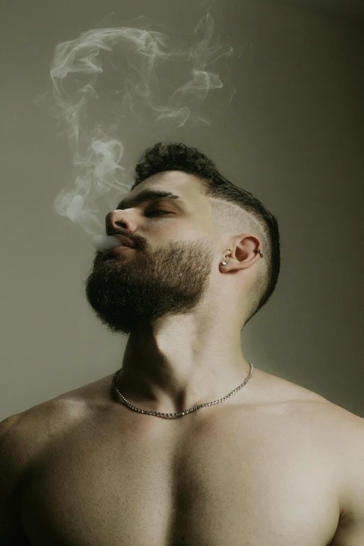 man with  smoking cigarette in profile