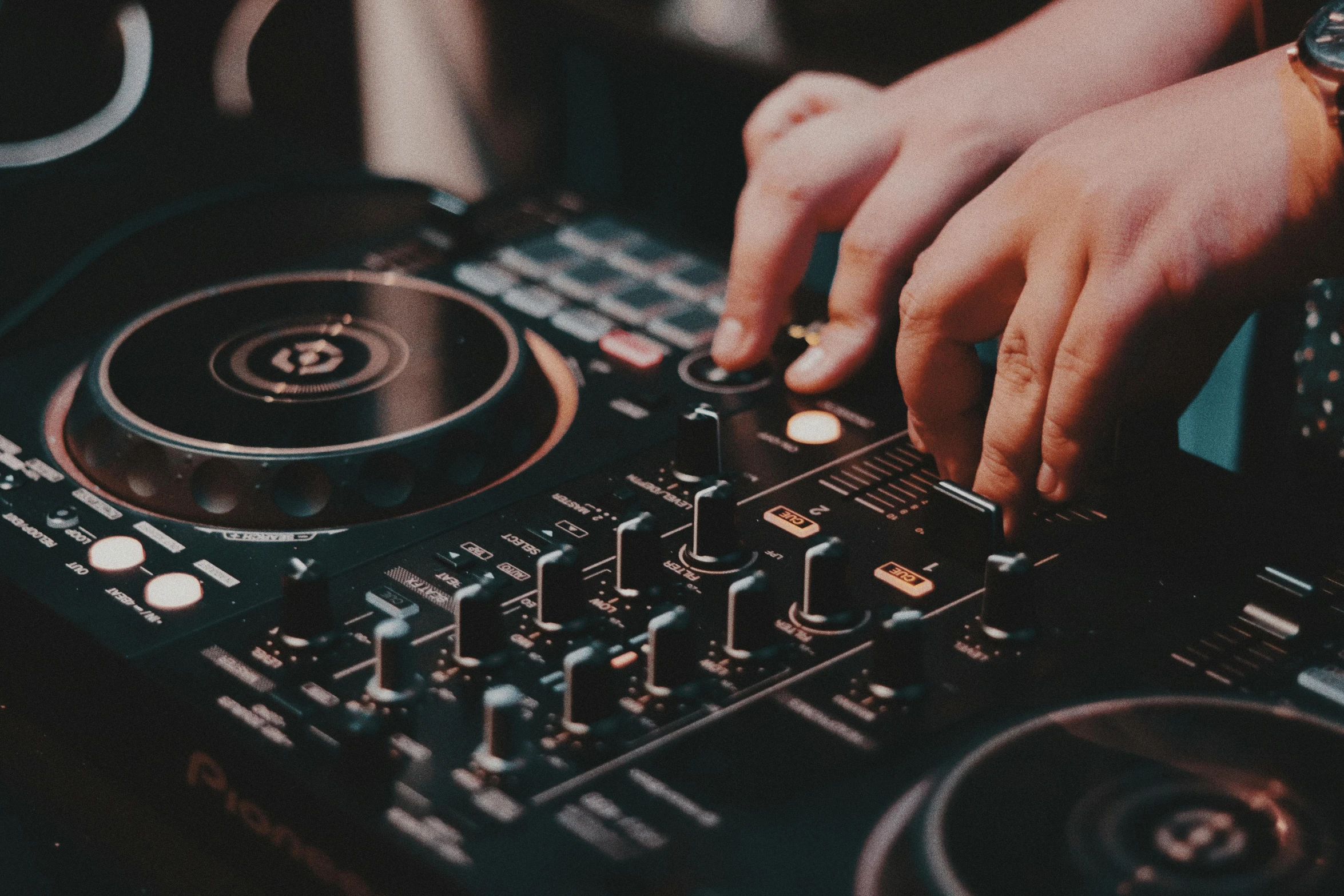 a dj spins the track with his hands