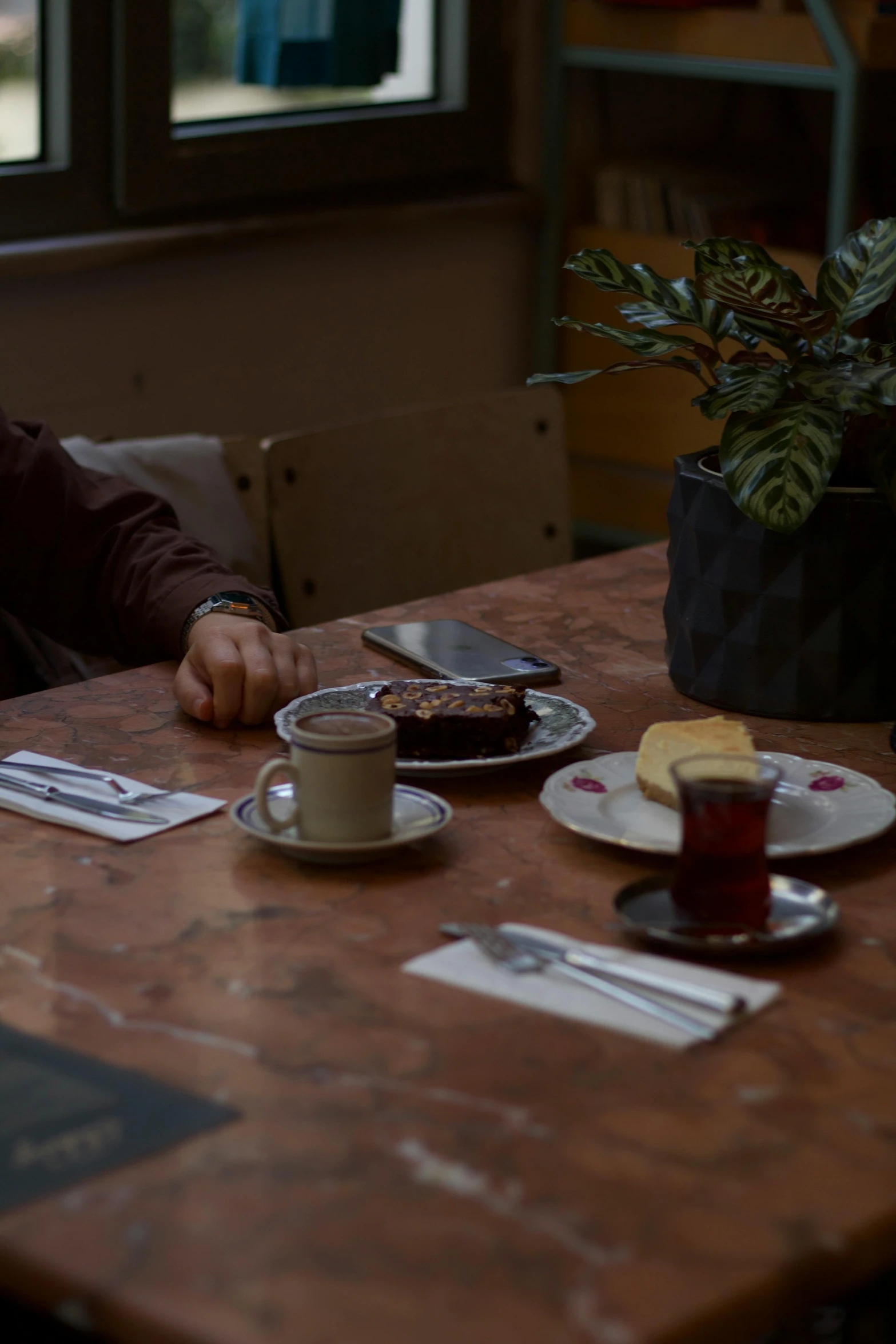 a person sitting at a table in front of a laptop computer