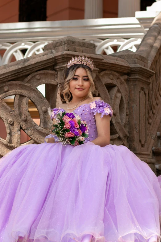 a girl in a lila dress posing on some stairs