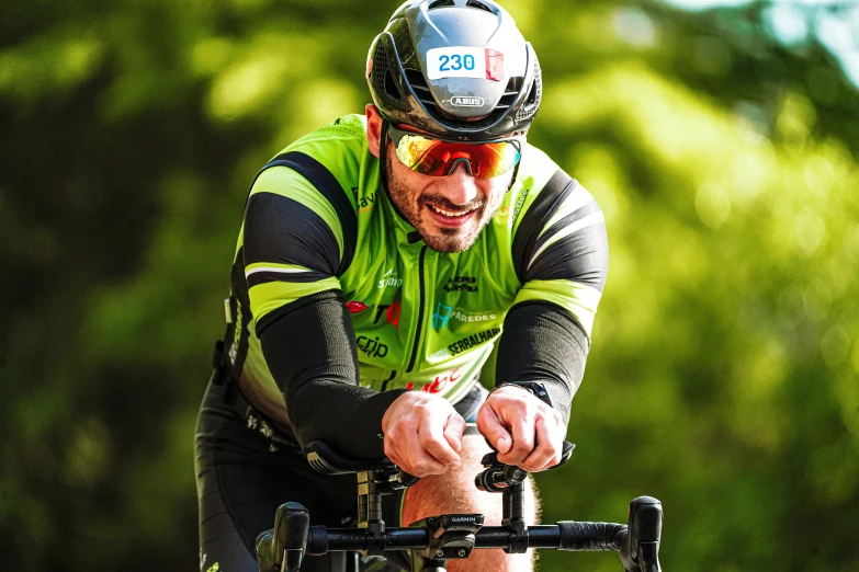 a person riding a bike with green and black clothes on