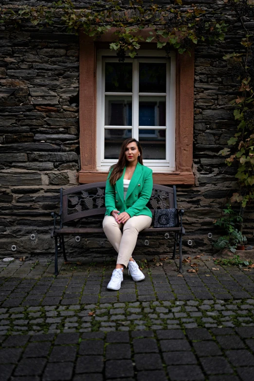 a woman sitting on a bench near a window