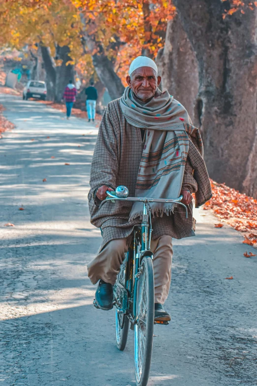 the man is riding his bicycle on the street