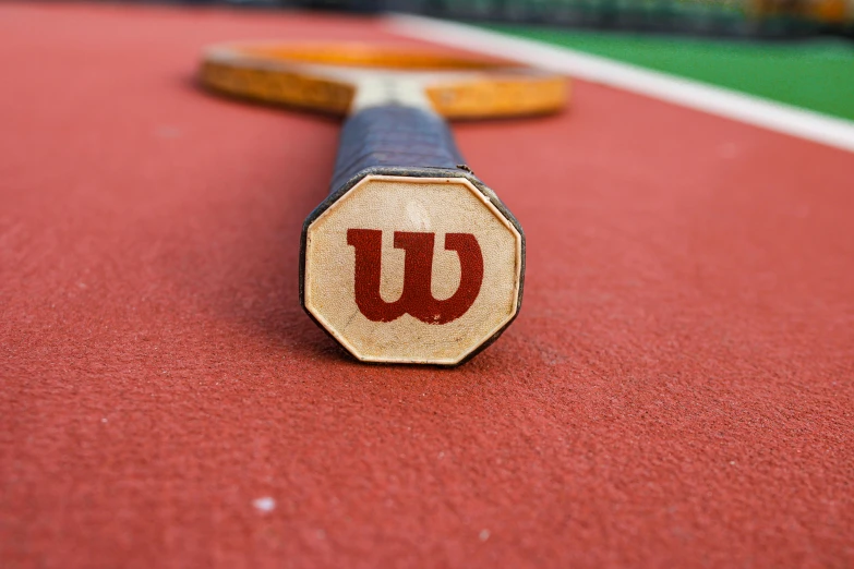 a close up view of a tennis racket that is on the ground