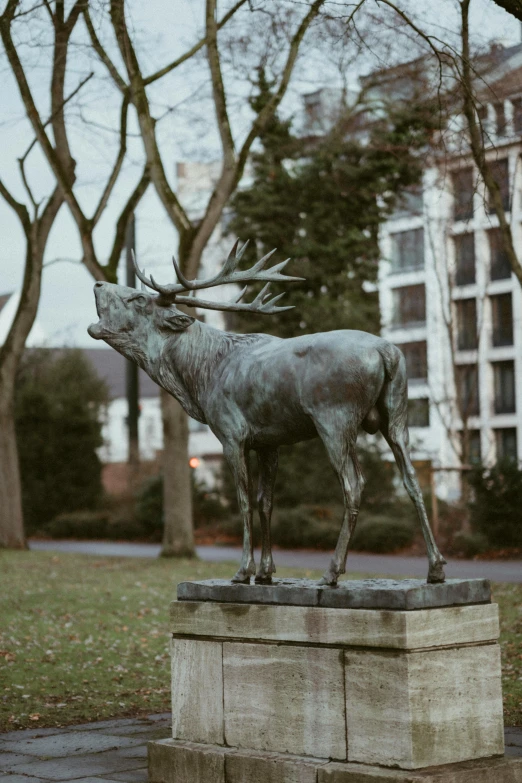 a silver statue is standing in the center of a street