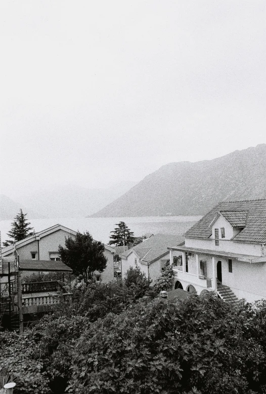 buildings sit in the fog of a mountain range