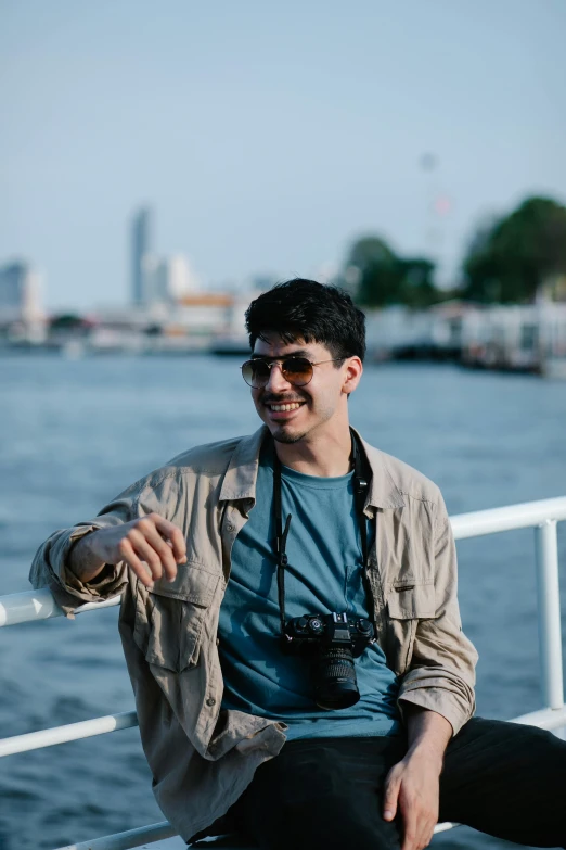 a man sitting on top of a boat on a lake